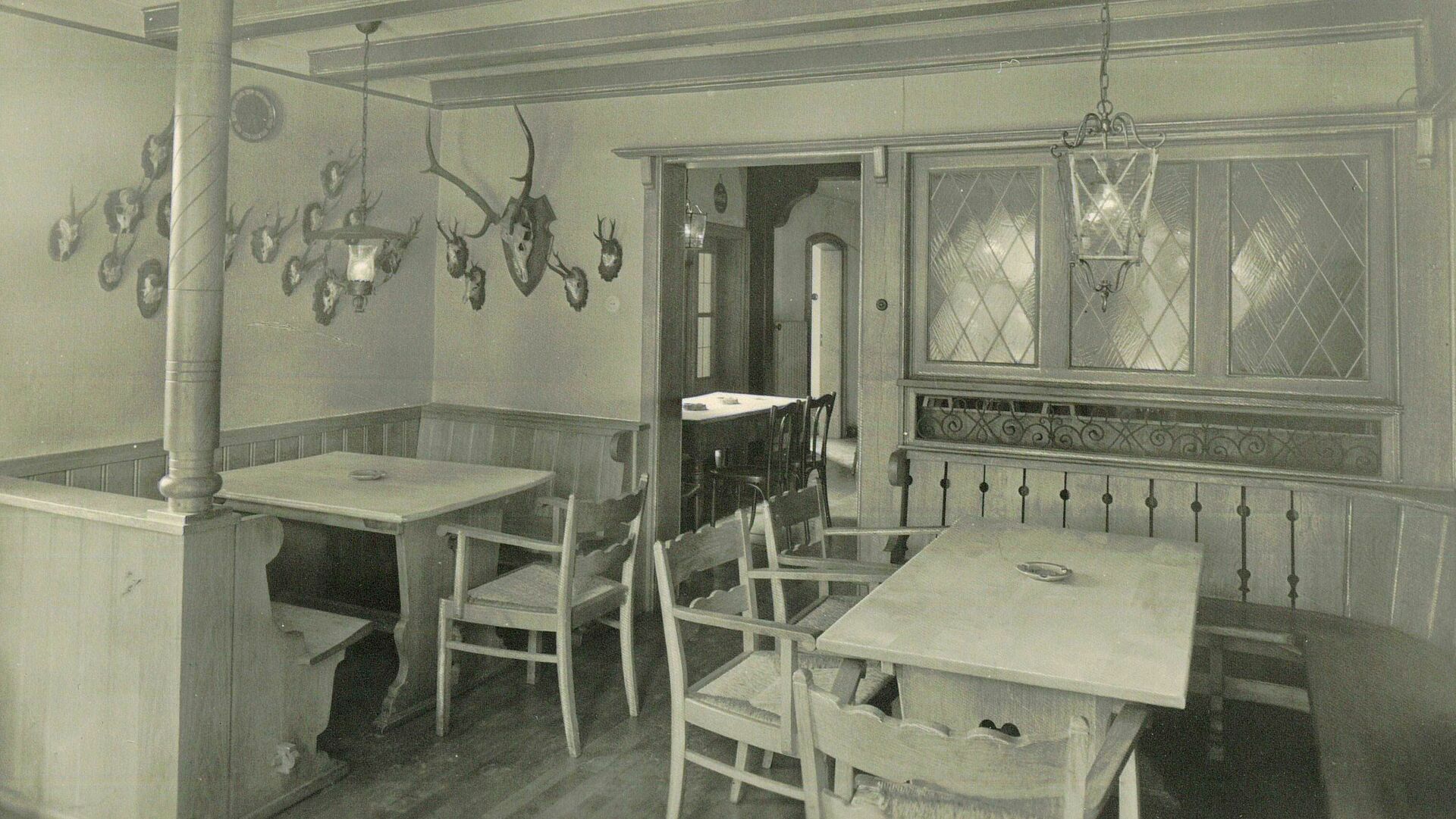 Raum mit Stühlen, Tischen und Bänken, schwarz-weiß Fotografie